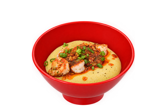 Shrimp and grits in a red bowl