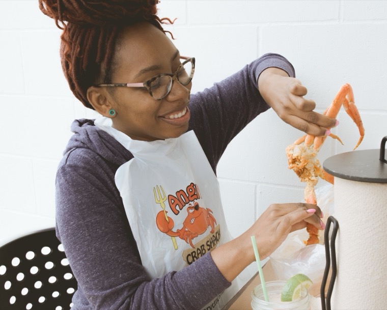 A guest pulling apart a crab leg