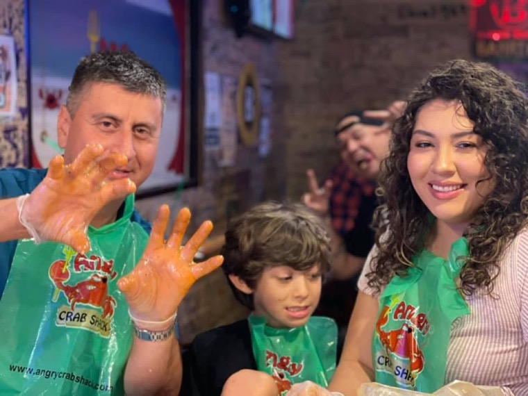 A guest showing seasoning-covered hands with a child