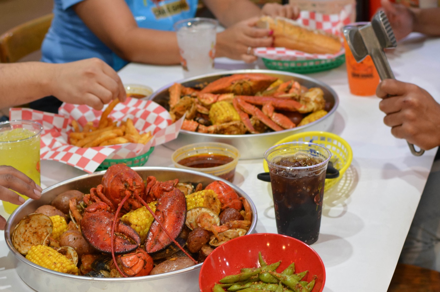 Guests around a seafood boil spread at the table