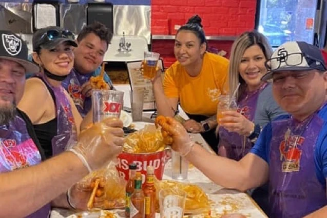A group of friends around a messy table of seafood