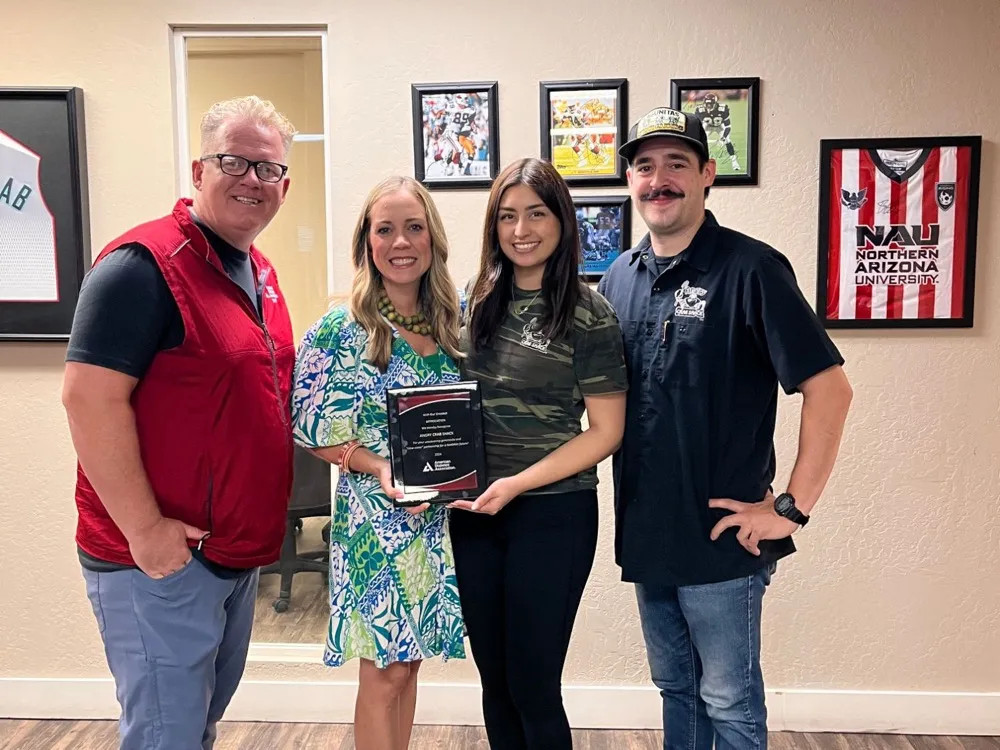 Four people holding an American Diabetes Association appreciation plaque