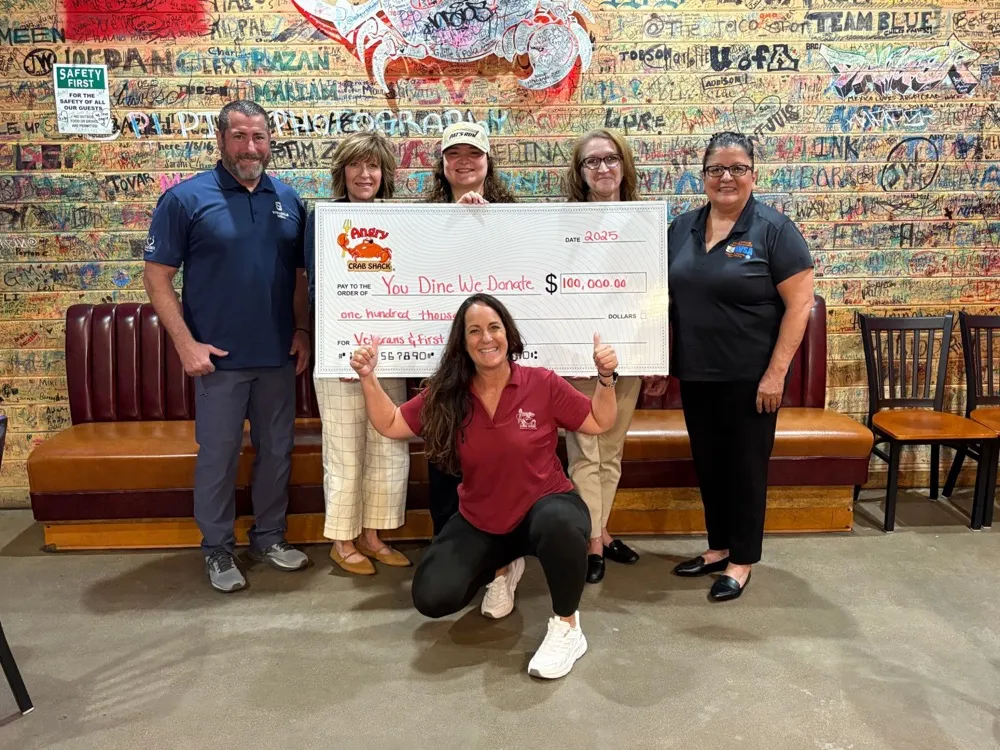 A $100,000 You Dine We Donate cheque for veterans and first responders