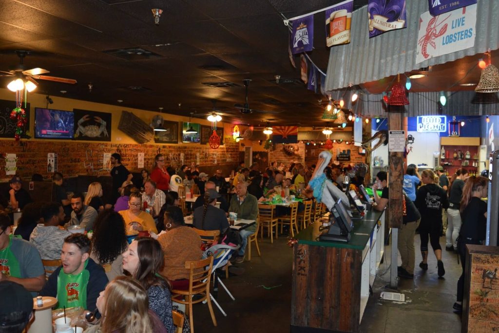 Families and groups dining at Angry Crab Shack casual seafood restaurant