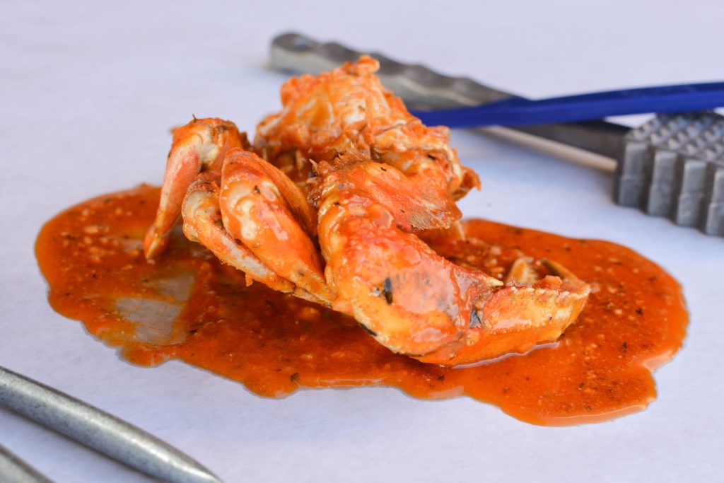 Fresh Dungeness crab boiled in signature Cajun spices and garlic butter at Angry Crab Shack